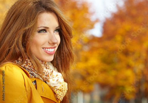 Portrait of beautiful young woman in autumn park.