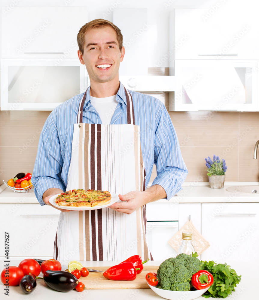 Young Man Cooking Pizza. Home. Kitchen Young Man Cooking Pizza. Home. Kitchen
