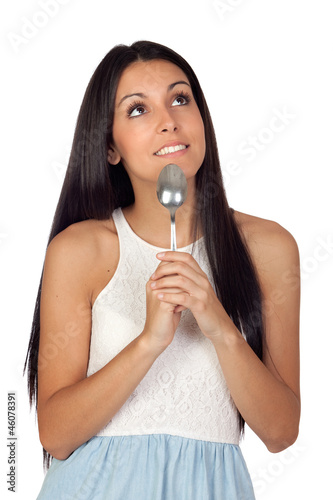 Attractive pensive girl with a spoon