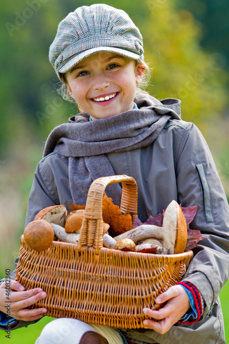 Obraz na plátně Season for mushrooms -  girl with basket of picked mushrooms