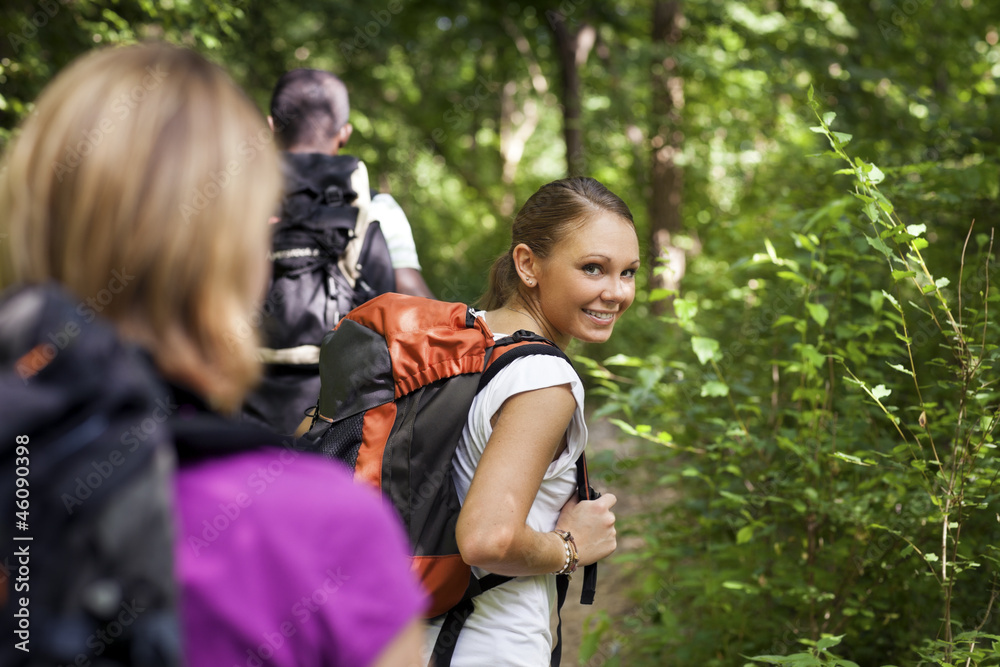 people with backpack doing trekking in wood people with backpack doing trekking in wood