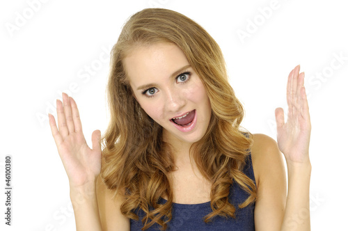 Portrait of young screaming woman with hands up