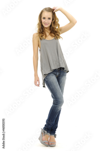 Pretty casual young fashion model in blue jeans posing