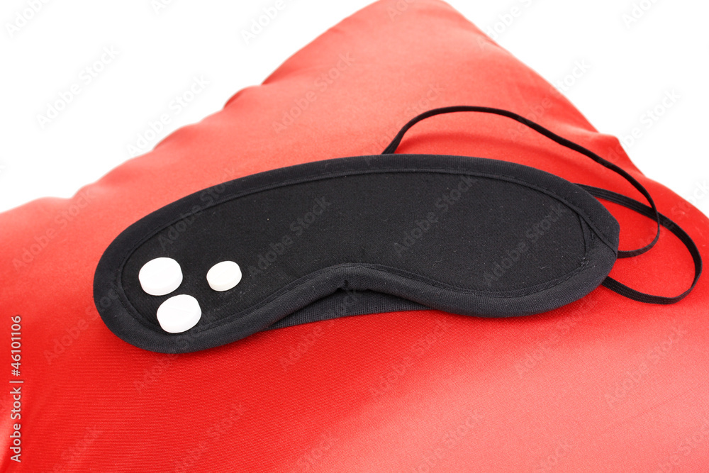 Sleeping mask and tablets on pillow isolated on white Sleeping mask and tablets on pillow isolated on white