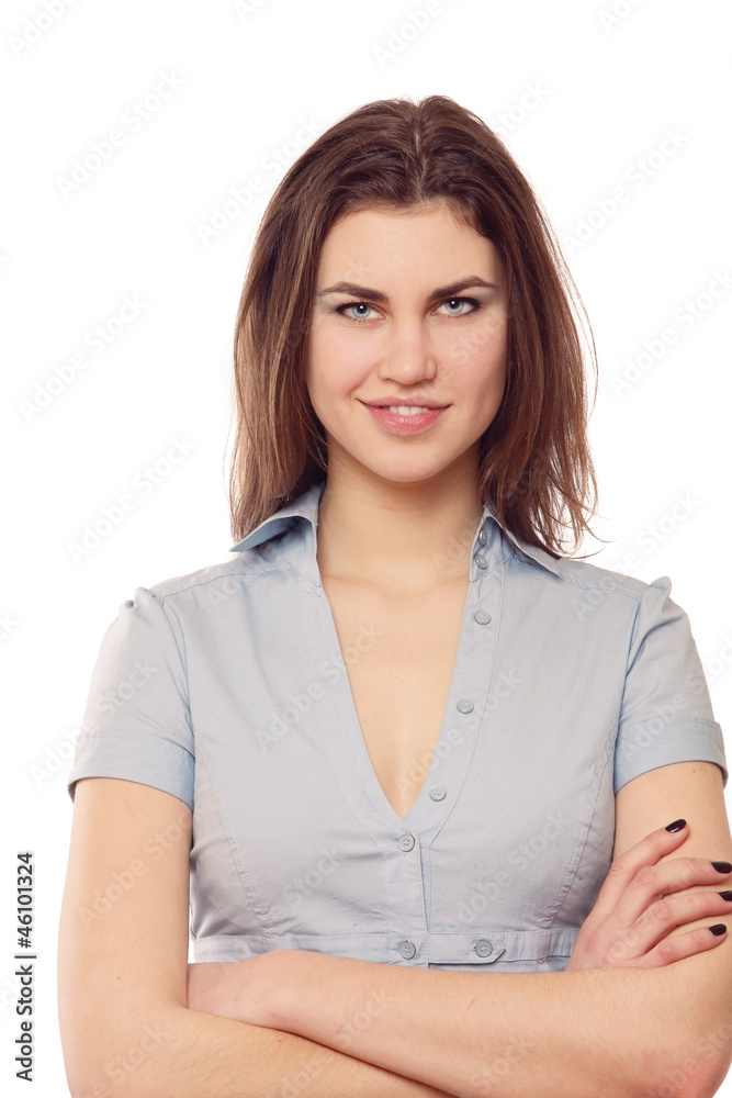 A smiling woman in blouse with crossed hands on white background A smiling woman in blouse with crossed hands on white background