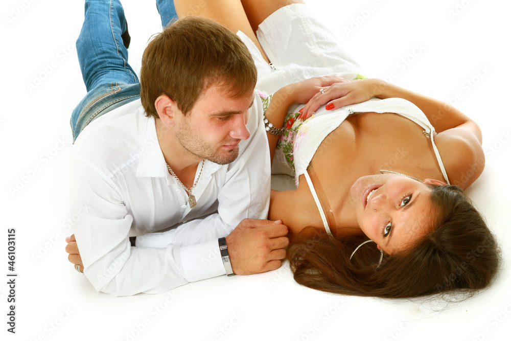 Fototapeta premium A young loving couple lying on the floor