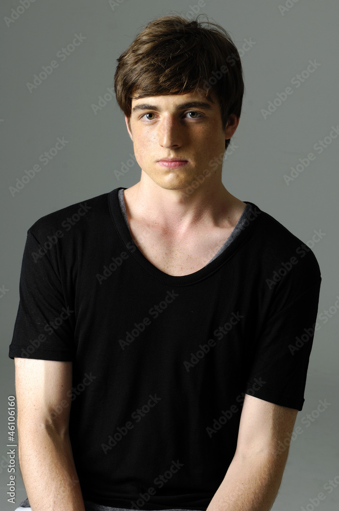 Young man in studio against a gray background