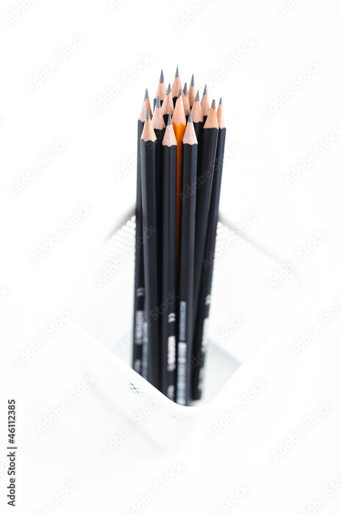 Black graphite pencils and yellow one in the metallic meshy box Black graphite pencils and yellow one in the metallic meshy box