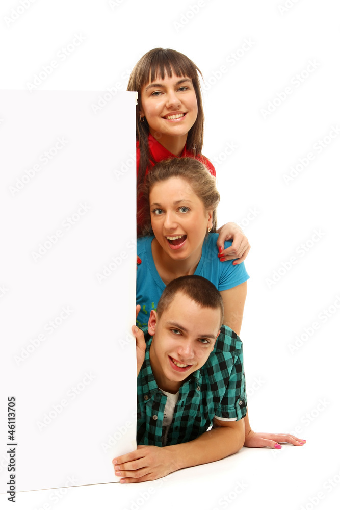 A company of friends are looking behind a blank A company of friends are looking behind a blank