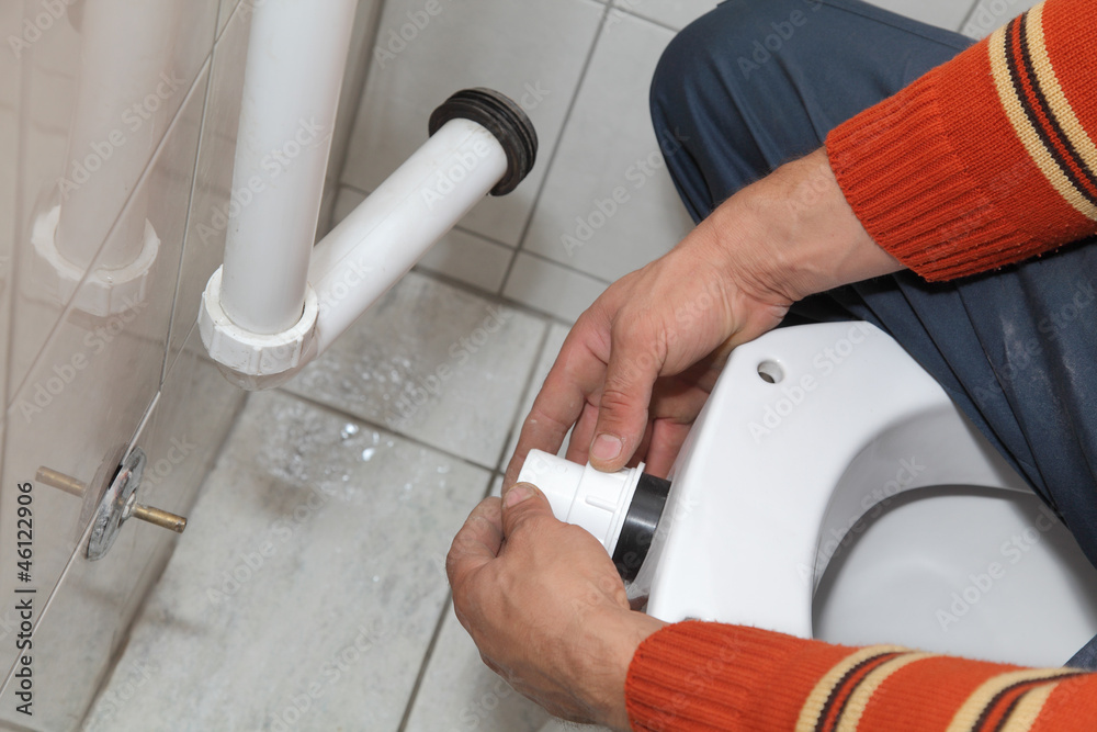 Plumber fixing plastic tube, wall mounted toilet cistern Plumber fixing plastic tube, wall mounted toilet cistern
