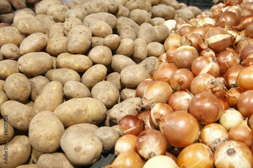 Potatoes and onions in a grocery