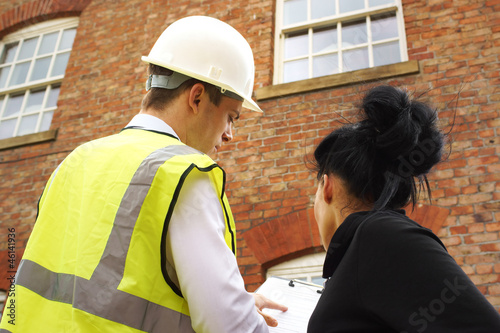 Surveyor or builder and homeowner discussing property issues