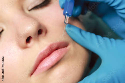 An injection of botox to a face - close-up image