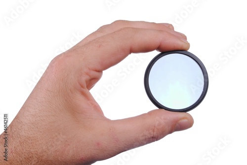 man hand holds a circular polarizer filter, isolated on white