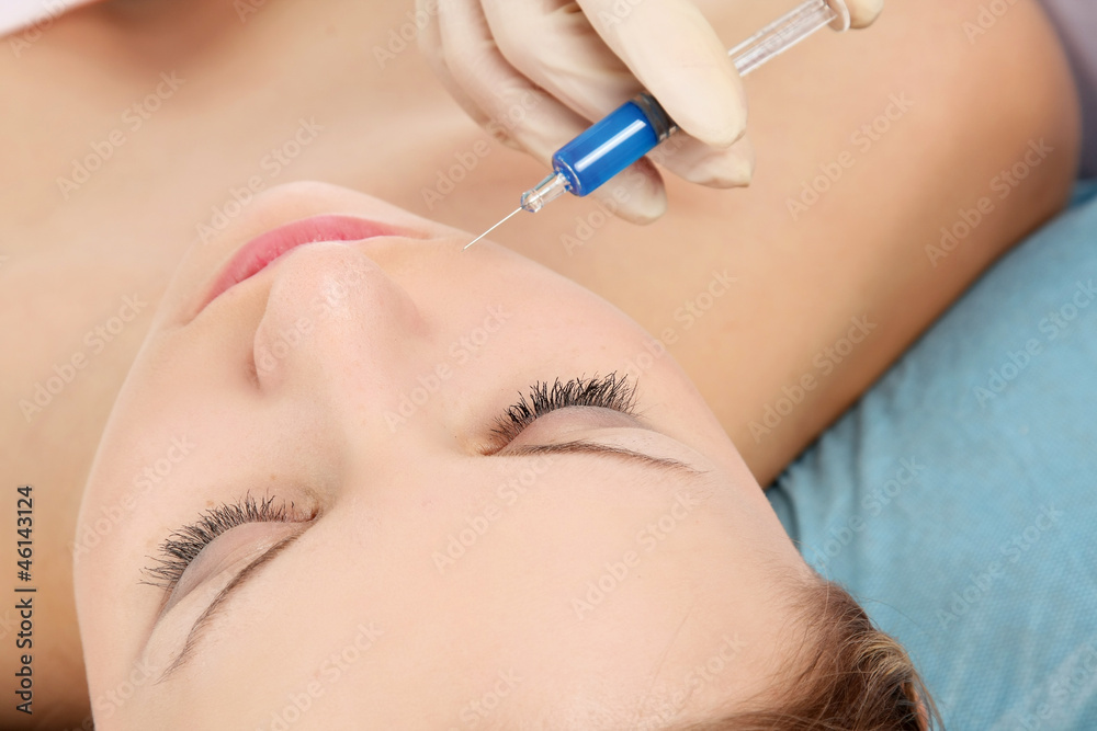 Close-up overhead of cosmetic injection in woman's face