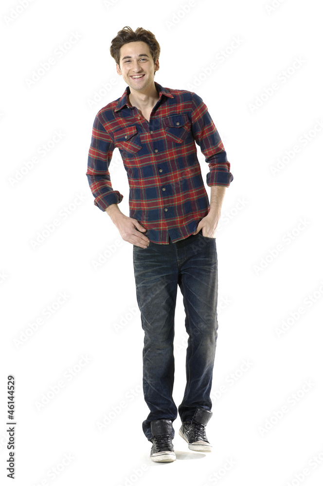 Full length young man standing with hands in pockets Full length young man standing with hands in pockets