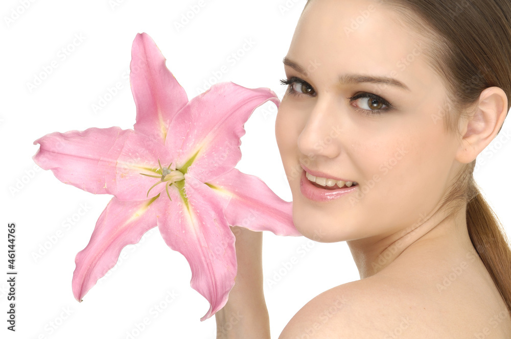 Close up young girl holding pink lily flower in her hands Close up young girl holding pink lily flower in her hands