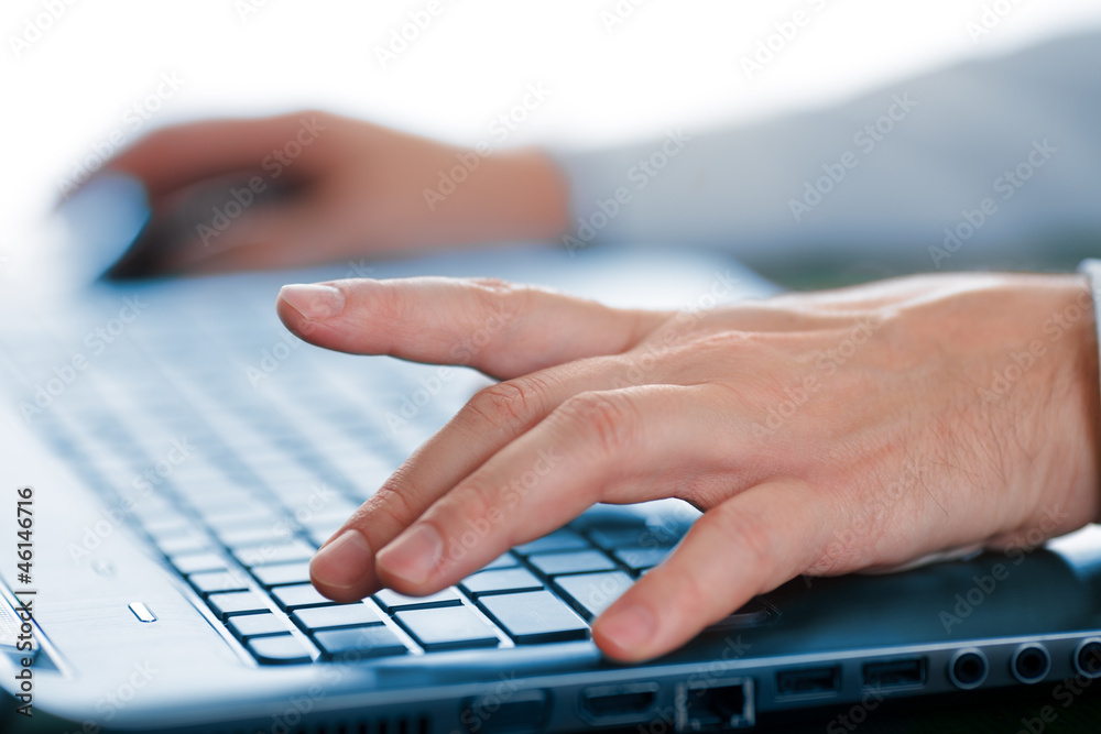 Hands typing on laptop keyboard Hands typing on laptop keyboard