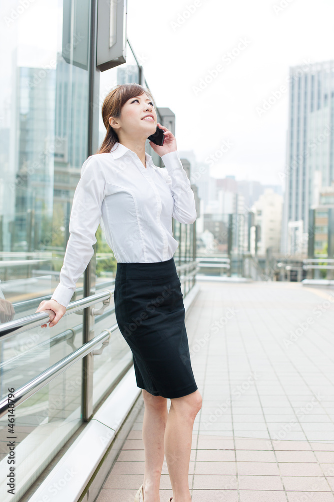 Beautiful business woman walking outside her office