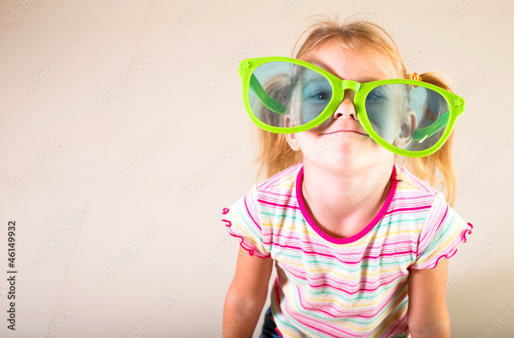 portrait of a little girl in big sunglasses