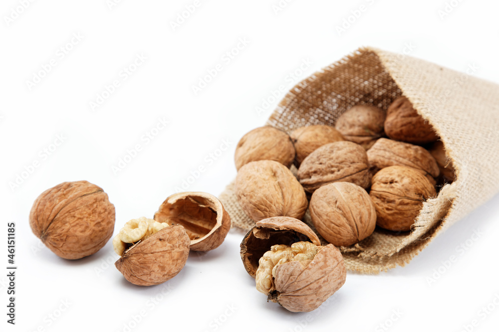 Walnut in a bag on a white background Walnut in a bag on a white background