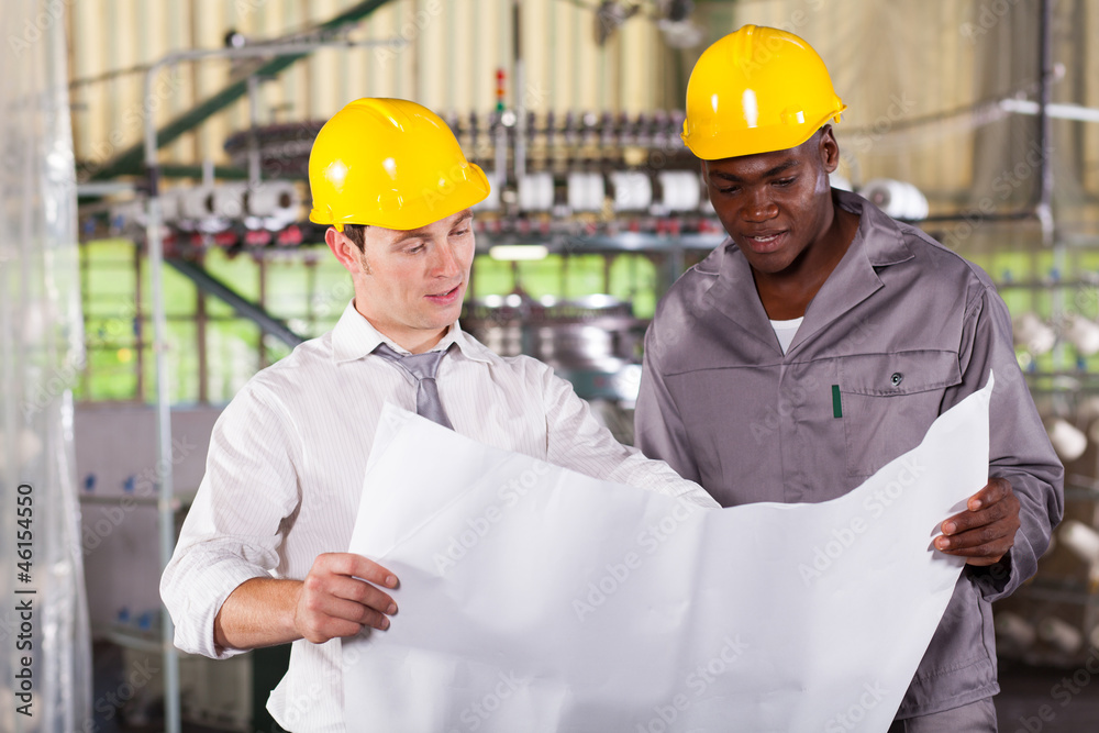 factory manager and worker looking at production plan