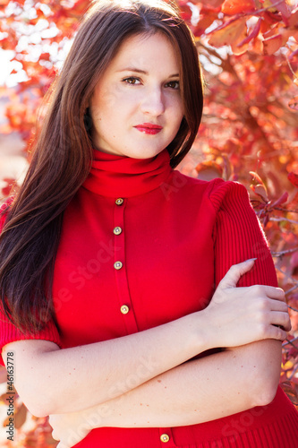 portrait of beautiful young woman in autumn leaves