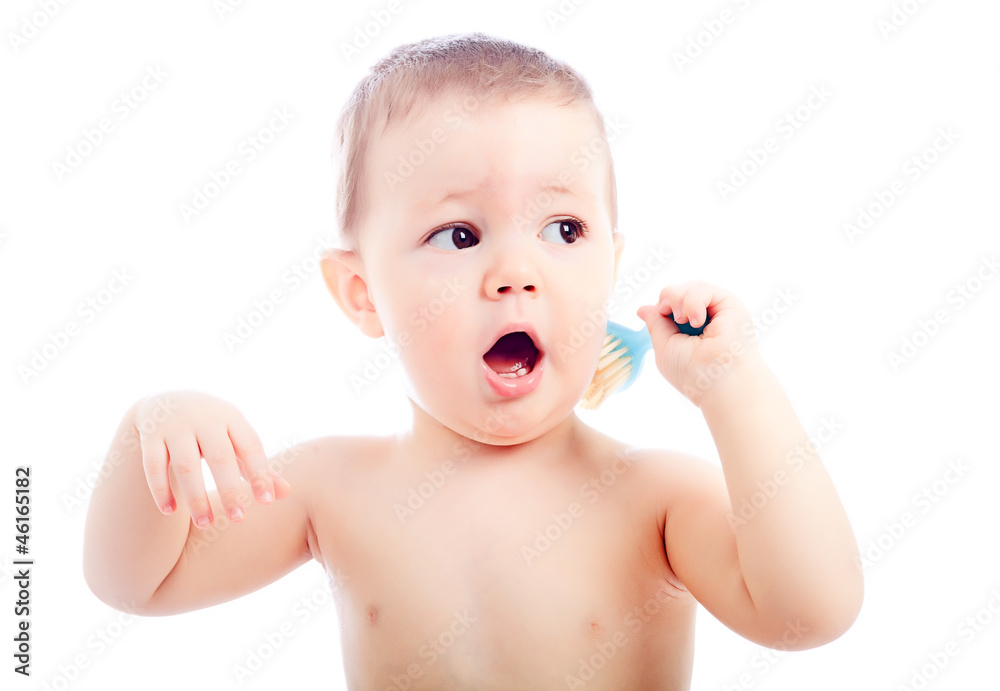 Portrait of lovely baby playing with comb, studio shot Portrait of lovely baby playing with comb, studio shot