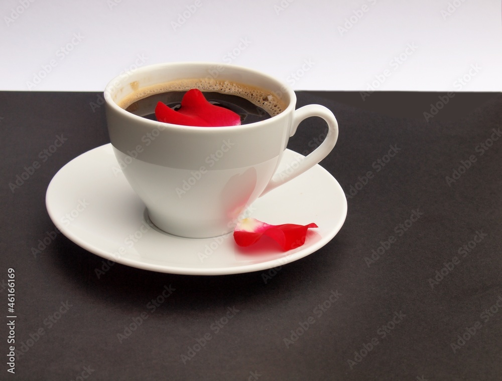 Cup of coffee scented by the red rose petal Cup of coffee scented by the red rose petal