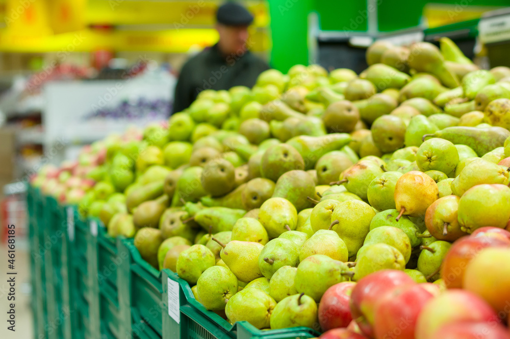 Bunch of green pears on boxes in supermarket Bunch of green pears on boxes in supermarket