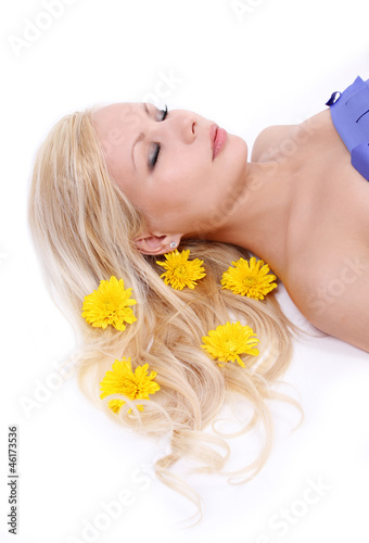 beautiful blonde young woman with yellow flowers in hair