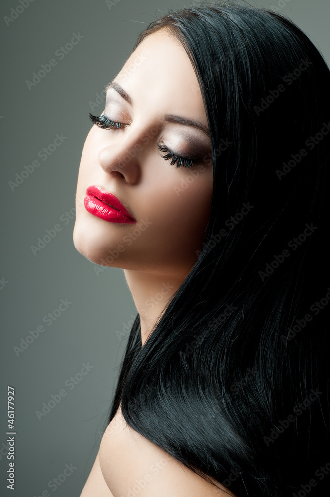 Fototapeta premium Brunette with perfect hair and red lipstick