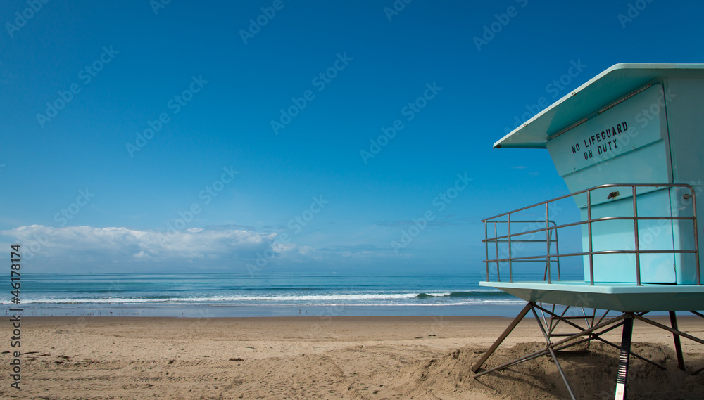 A Life Guard Stand on a beach with the ocean