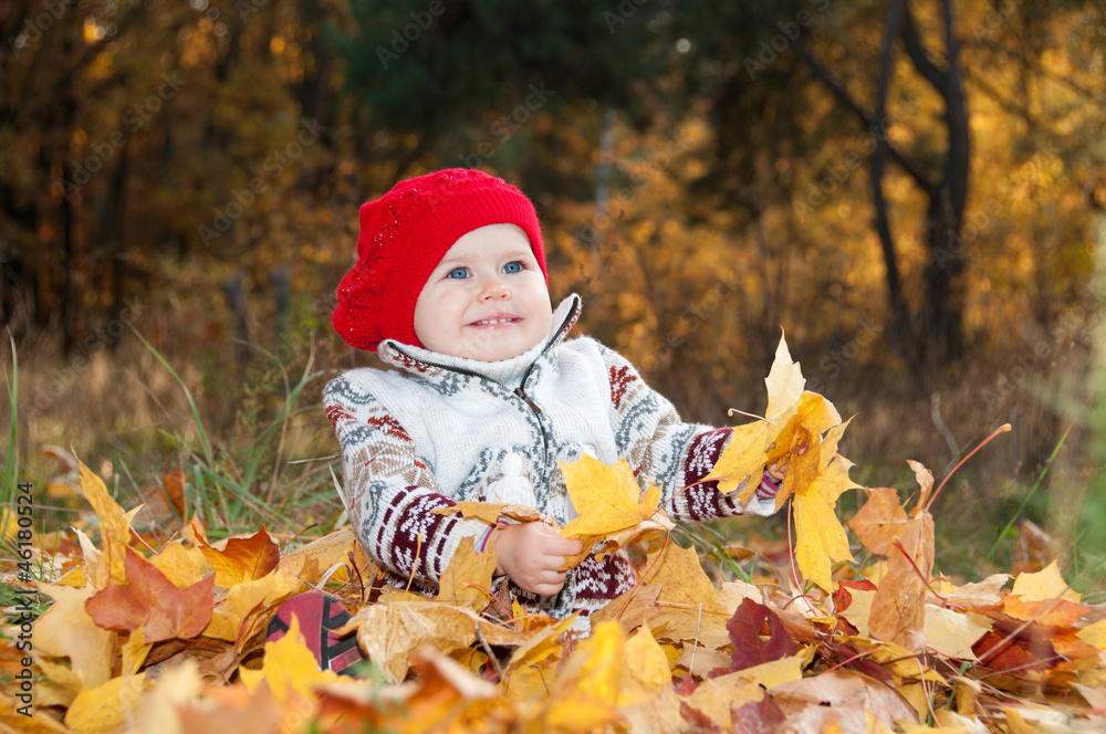 Little cute baby girl on a background of autumn leaves Little cute baby girl on a background of autumn leaves