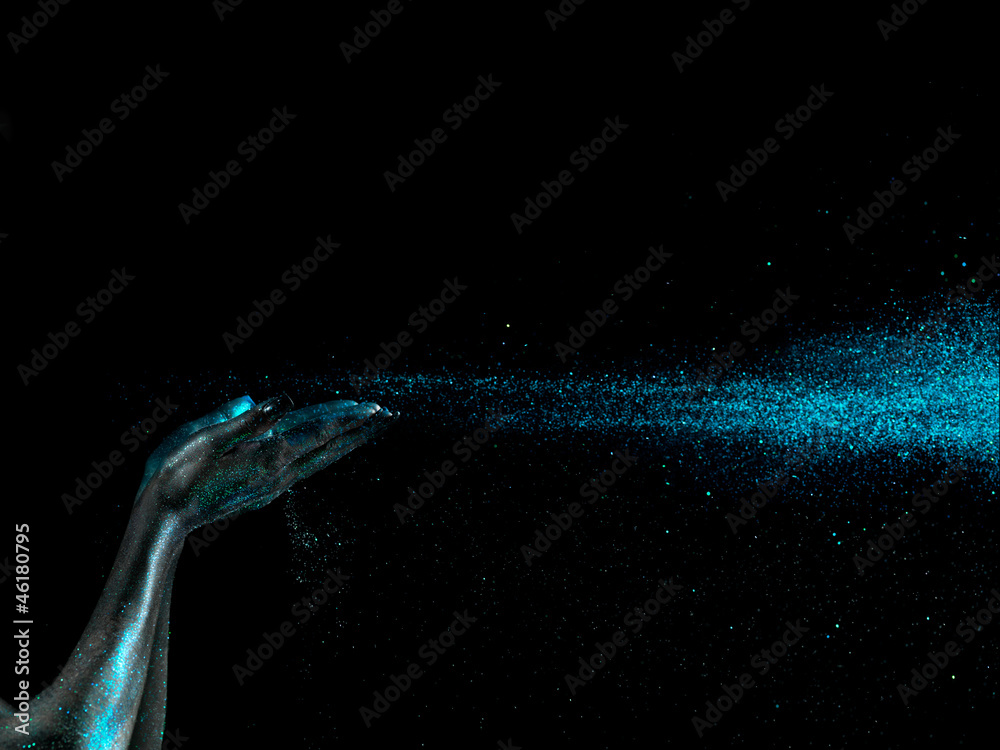 Fototapeta premium glitter falling from woman's hands black background