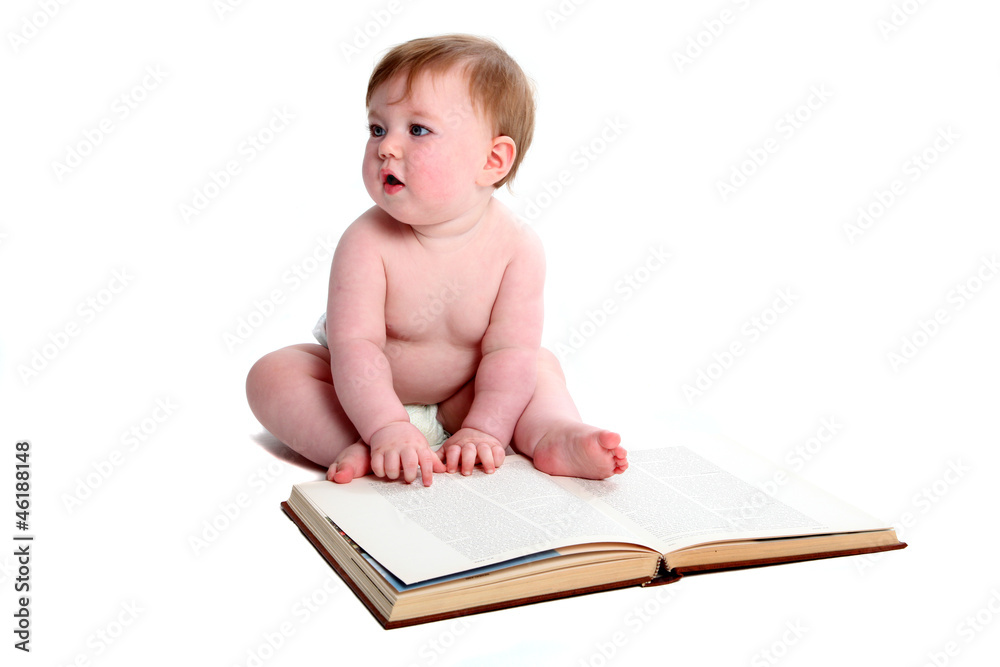Baby girl paging through a textbook Baby girl paging through a textbook