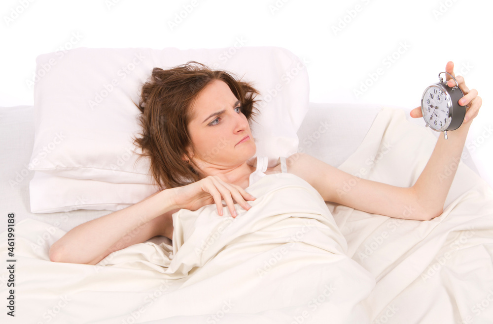 Women into bed with alarm clock Women into bed with alarm clock