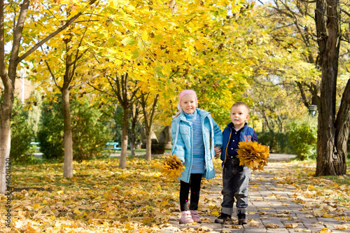 Brother and sister in autumn park