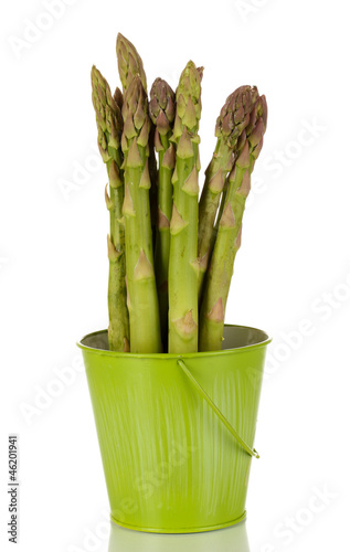 Fresh asparagus in green pail isolated on white.