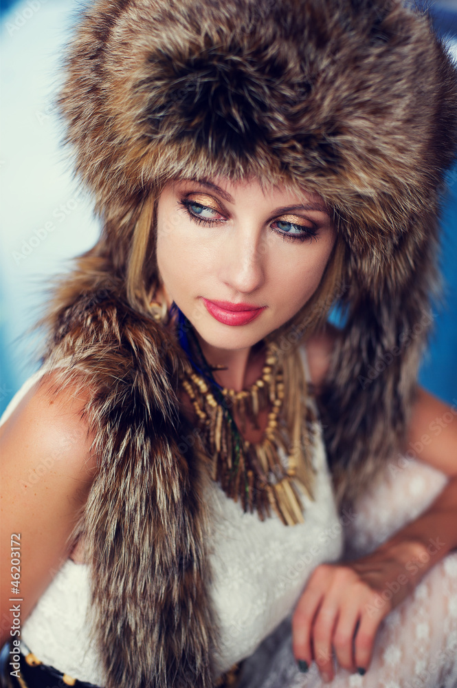 Fashion portrait of a woman in fur next to the swimming pool. Fashion portrait of a woman in fur next to the swimming pool.
