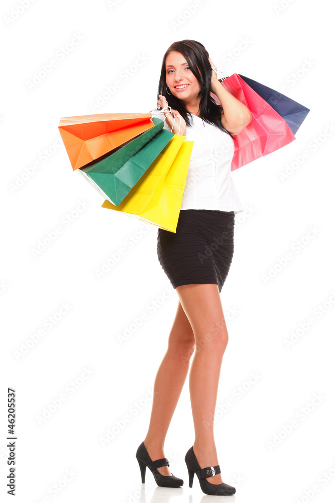 Portrait of young woman carrying shopping bags against white bac Portrait of young woman carrying shopping bags against white bac