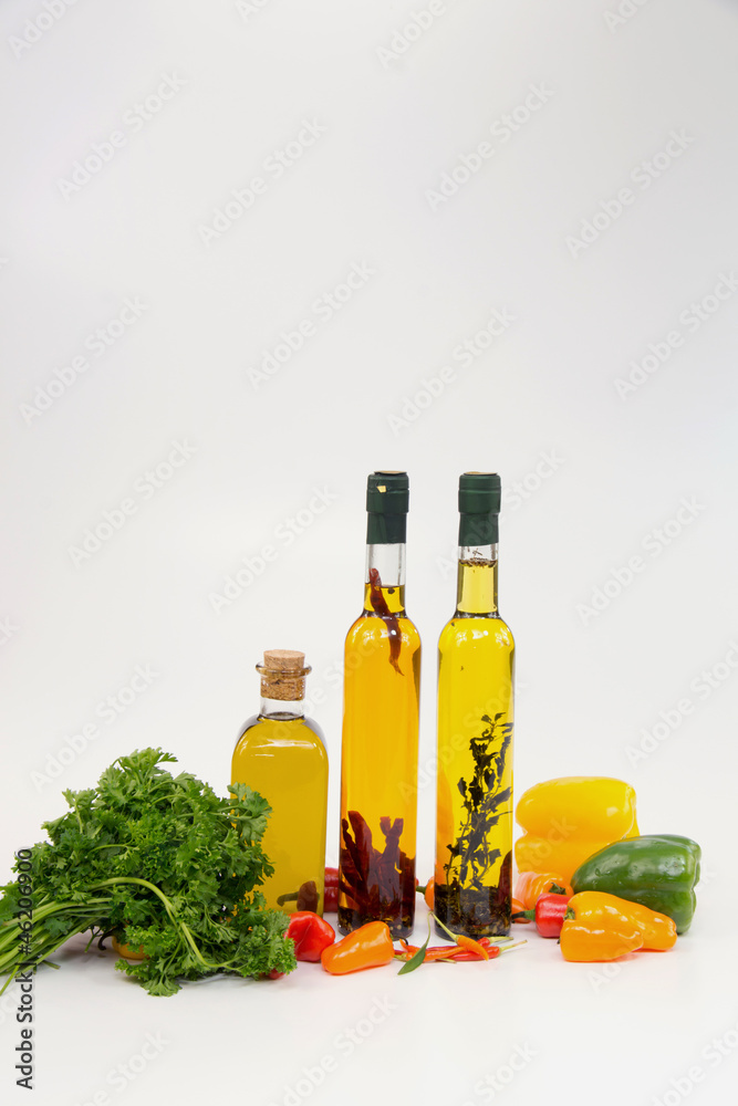 Olive oil in bottle with peppers and vegetable Olive oil in bottle with peppers and vegetable
