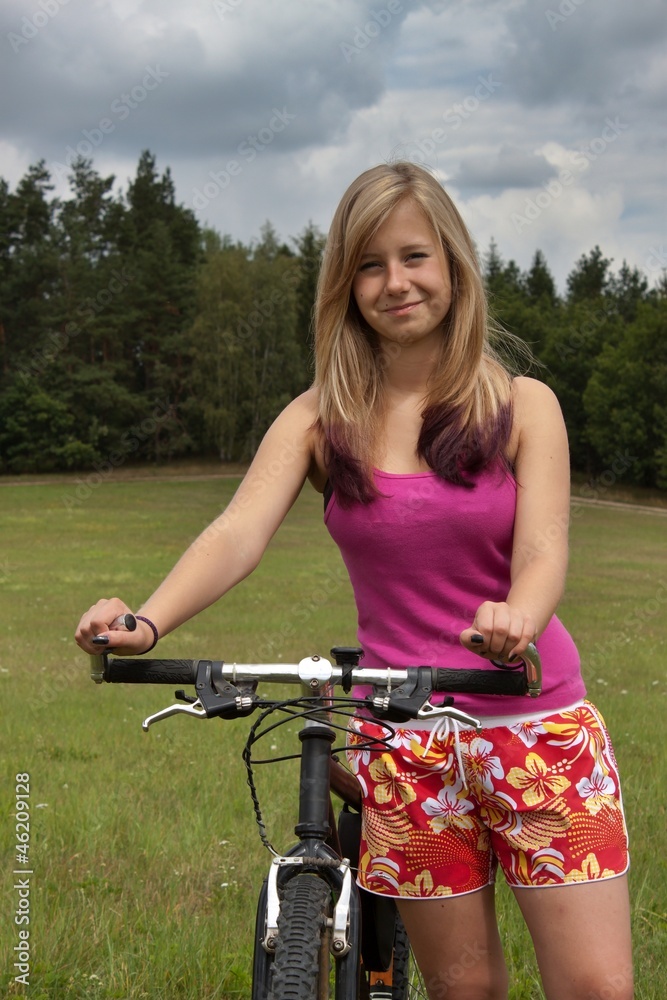young blond girl on a bicycle trip
