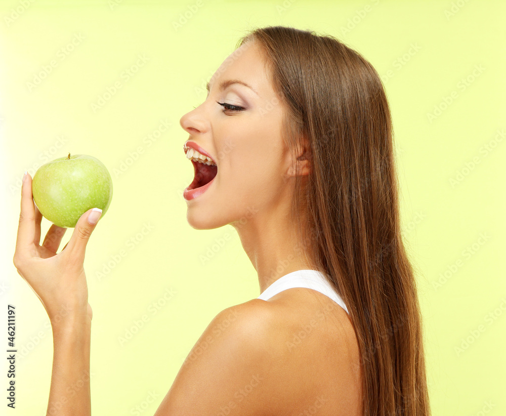 beautiful young woman with green apple, on green background beautiful young woman with green apple, on green background