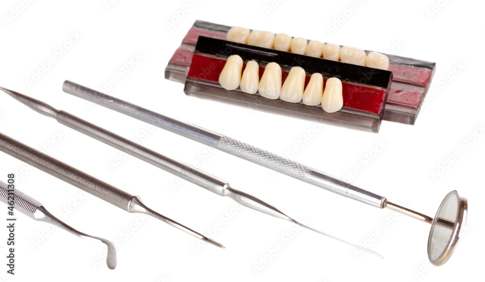 denture with dental tools isolated on white denture with dental tools isolated on white