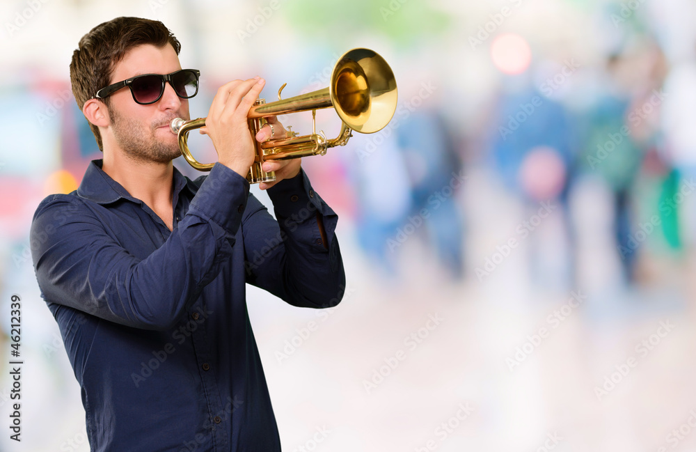 Obraz premium A Young Man Blowing A Trumpet