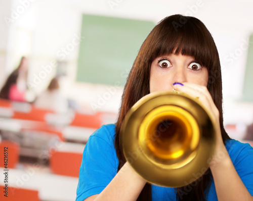 portrait of a teenager playing trumpet photo