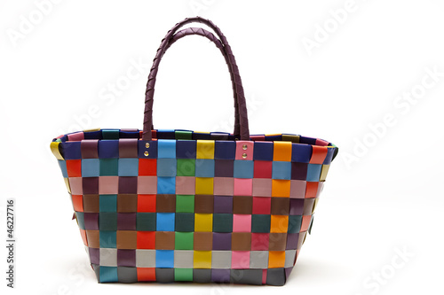 colorful woven shopping bag, isolated on white.