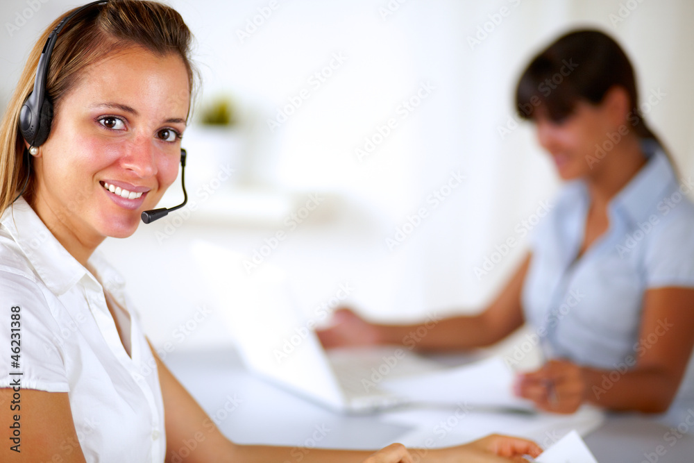 Young friendly receptionist wearing headphone