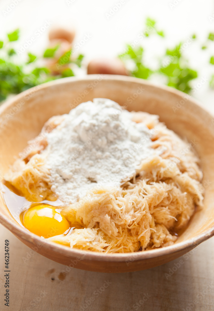 Grated raw potatoes with flour and eggs Grated raw potatoes with flour and eggs
